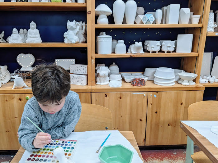 Child painting at Color Me Mine