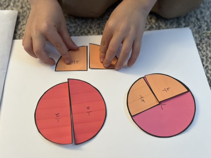 student working on fractions with colorful circles and circle parts