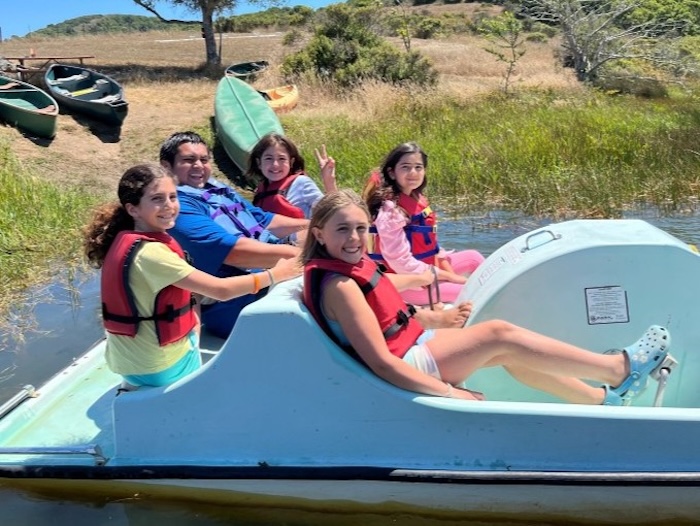 youth campers are using a pedal boat
