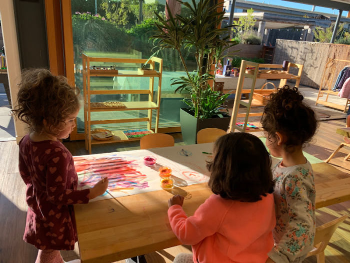 three golestan school preschool children making art
