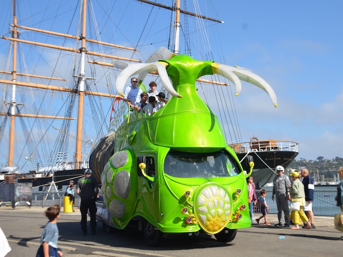 giant green art car vehicle on the waterfront