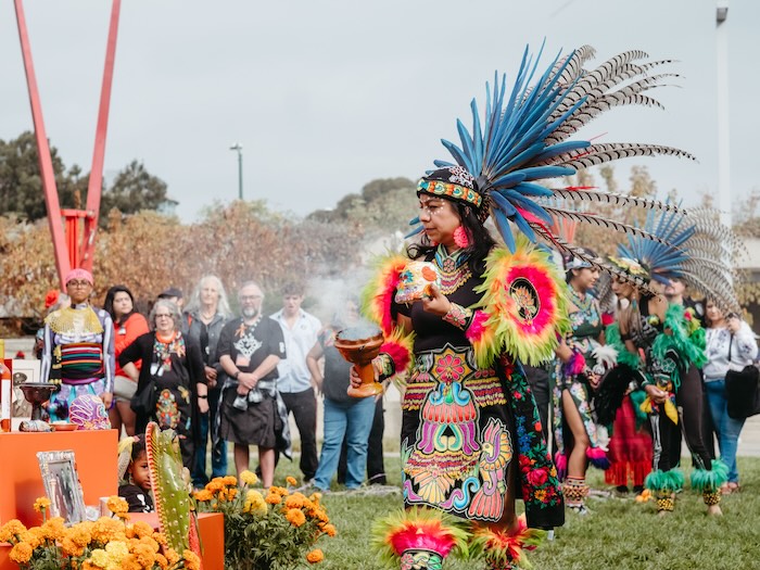 person doing sacred dia de los muertos rituals