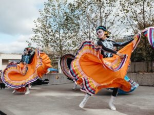 orange dress dancers doing folklorico dance