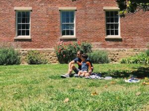 adult and child eat on the lawn in benicia