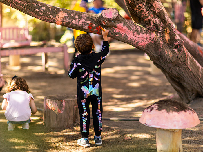 Bay Area Discovery Museum Goblin Jamboree kid in costume painting a tree