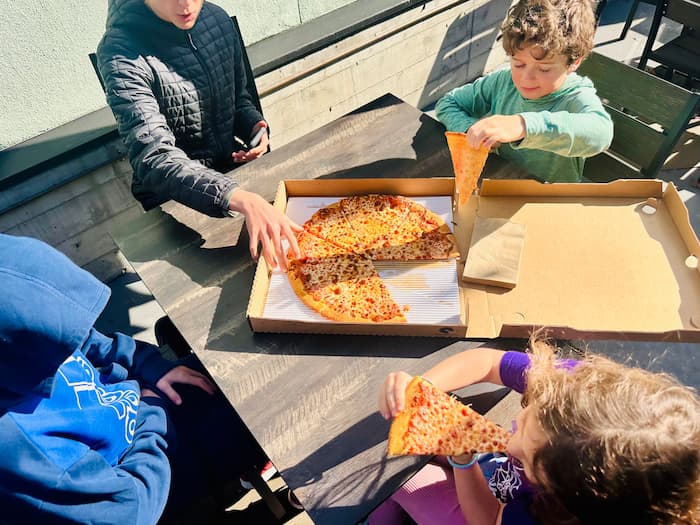 kids eating pizza out of box