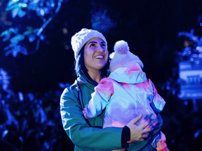 mom and baby looking at illumnated tree