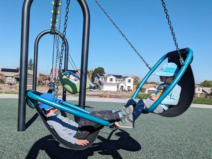 Swings at the all-abilities play structure in Martinez