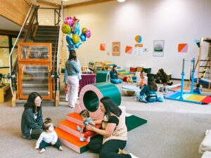 spirited play labs moms and babies on the floor exploring