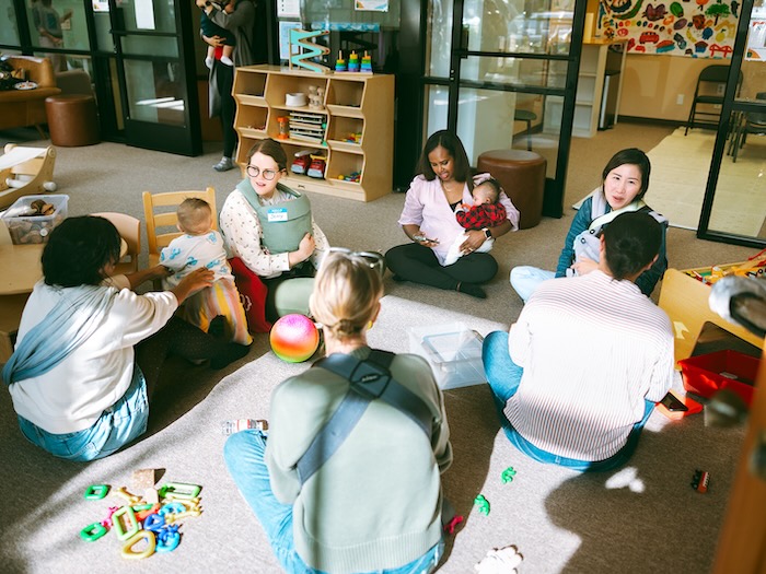 moms and babies seated on the floor in Spirited play Labs berkeley