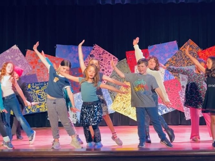 kids on stage doing a dance