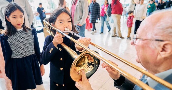 child trying a trombone