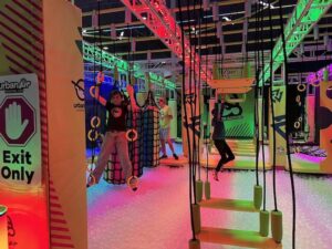 two teens on an obstacle ninja warrior course