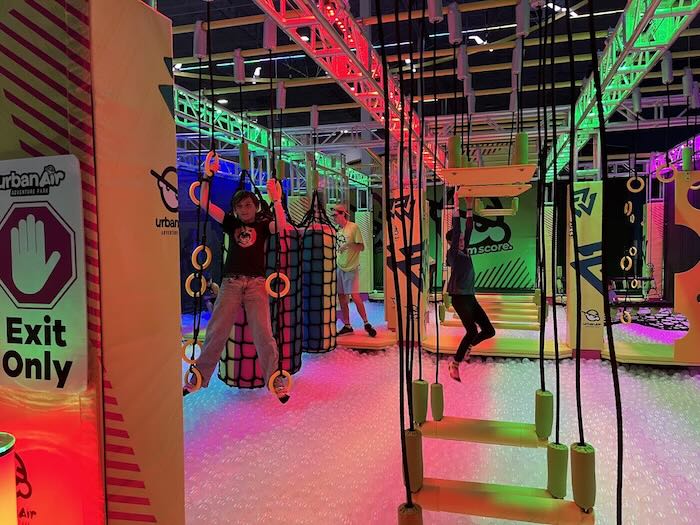 two teens on an obstacle ninja warrior course
