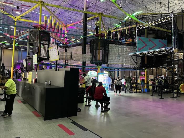 urban air expansive indoor play area with ceiling zip lines, ropes course, and vertical playground