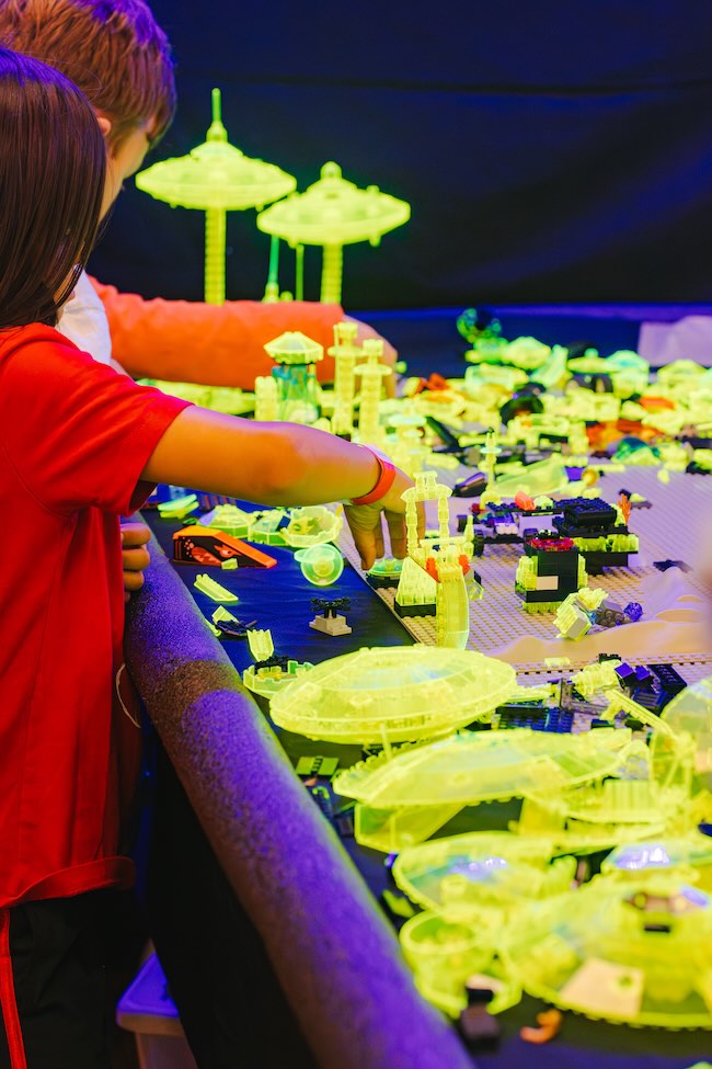 kids playing with blacklight lego sets