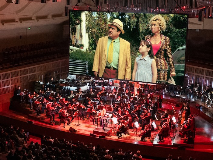 Matilda the movie on stage with a full orchestra