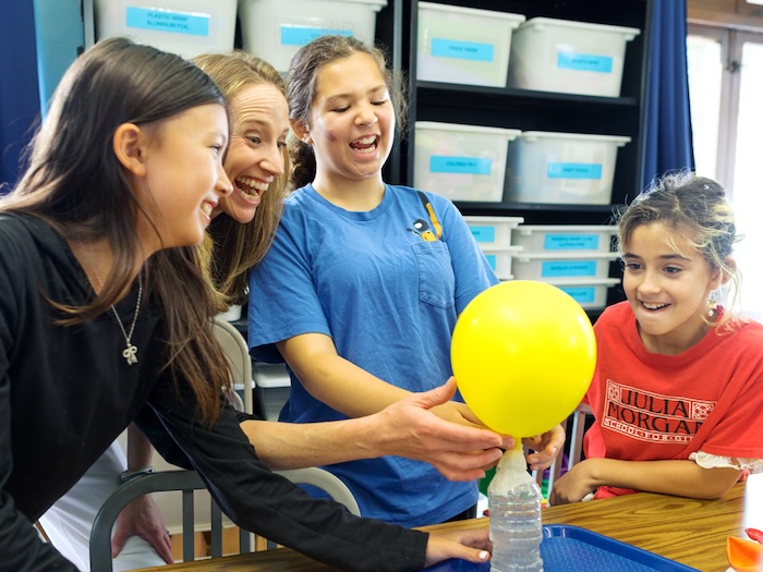 middle school girls doing science experiment