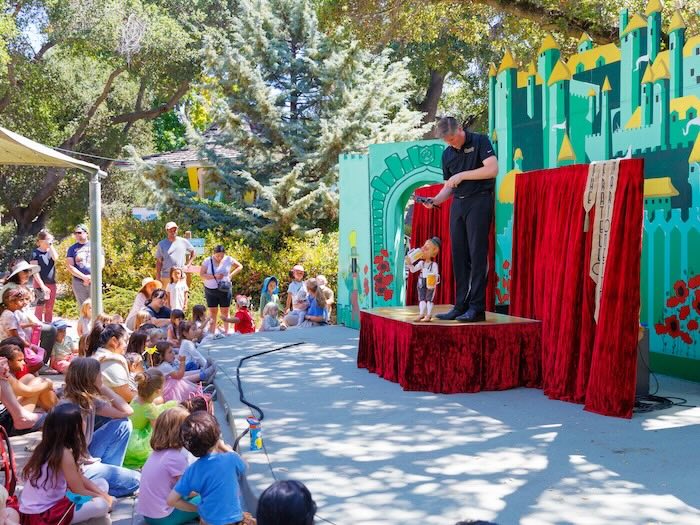 children watch a puppet show at fairyland