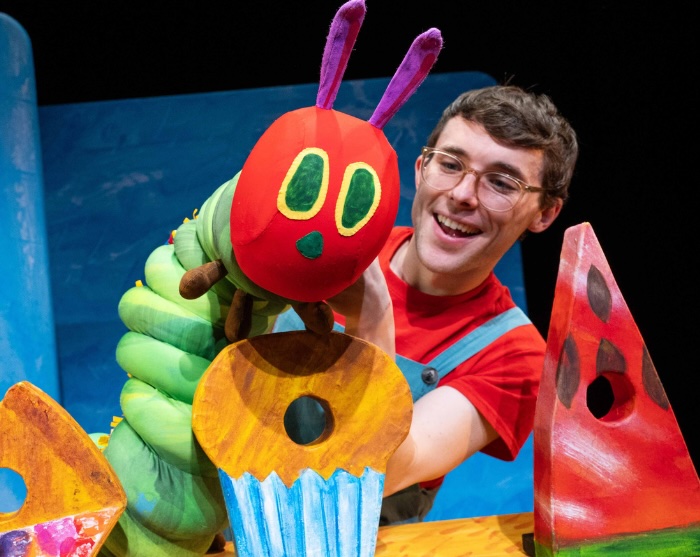 man puppet and giant fake food from The Very Hungry Caterpillar
