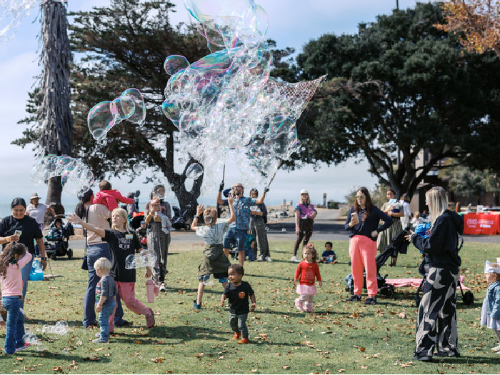 bubble show on the lawn by kind bubbles for lots of kids and adults at the waterfront