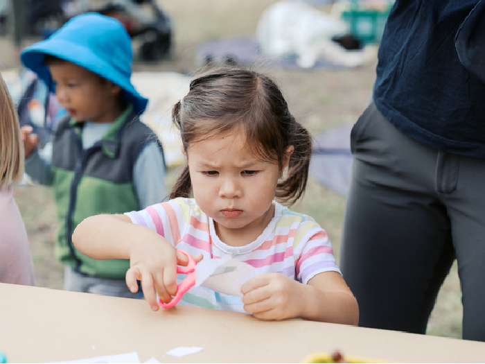child carefully cutting a fish crown at crab cove