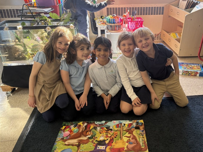 five kids on a rug solving a colorful puzzle