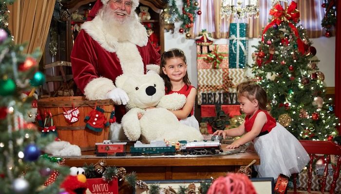 santa claus with two girls in a christmas vignette